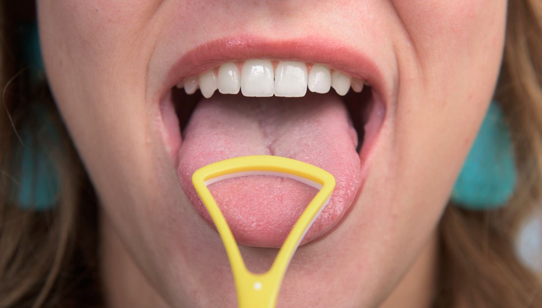 You really should add tongue scraping to your oral care routine.